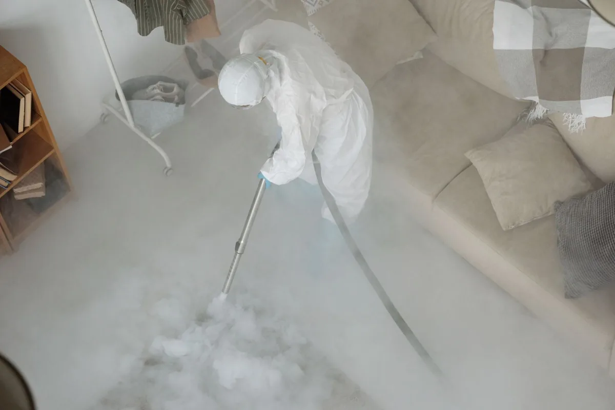 Biohazard cleanup technician in protective equipment, Ward, AR